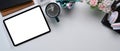 White office desk with mock up digital tablet with empty screen, coffee cup and office supplies. Royalty Free Stock Photo