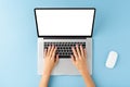 Overhead shot of womanÃ¢â¬â¢s hands using laptop with blank display on blue background. Modern workspace concept. Royalty Free Stock Photo