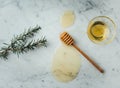 Overhead shot of a wood dipper of honey and honey on a marble surface Royalty Free Stock Photo