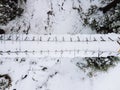 overhead top view of snowed bridge in the forest