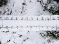 overhead top view of snowed bridge in the forest