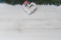 Overhead top view of a white heart hanging on a fir branch with Christmas decorations