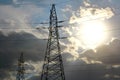 Overhead transmission of electricity through high voltage lines with ropes between high columns. Royalty Free Stock Photo