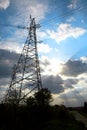 Overhead transmission of electricity through high voltage lines with ropes between high columns. Royalty Free Stock Photo