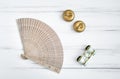 Overhead view of accessories for a visit to opera or theater: lorgnette and wooden fan. Vintage flat lay