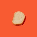 Overhead view of arranged slice of fresh white bread with sesame seeds against orange background. Bakery concept Royalty Free Stock Photo