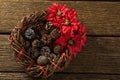 Overhead view of artificial nest with pine cones and poinsettia flowers Royalty Free Stock Photo