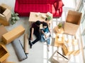Overhead view of Asian young couple lover moving to new property and start a small business together while checking purchase order Royalty Free Stock Photo
