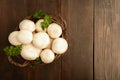 Overhead view of basket with champignon and greens