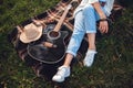 Overhead view of beautiful woman with guitar resting on green lawn. Top view