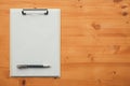 Overhead view of blank clipboard note pad paper with pen Royalty Free Stock Photo