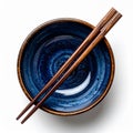 Overhead View of Blue Ceramic Bowl with Wooden Chopsticks on White Table Royalty Free Stock Photo