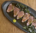 Overhead view of bonito sashimi fillets with wasabi sauce and seaweed Royalty Free Stock Photo