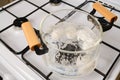 Overhead view of borosilicate saucepan with boiling eggs on a gas stove