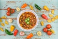 Overhead view of bowl of chili garnished with jalapeno slices