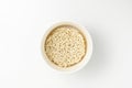 Overhead view of bowl with raw instant Asian egg noodles on white background