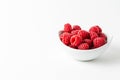 Overhead view of bowl with red raspberries on white background horizontal Royalty Free Stock Photo