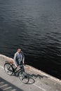 overhead view of businessman with bike walking on quay