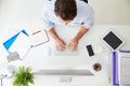 Overhead View Of Businessman Working At Computer In Office