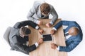 Overhead view businessmen using tablet during meeting