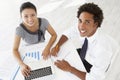 Overhead View Of Businesswoman And Businessman Working At Desk Together