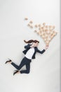 overhead view of businesswoman with disposable cups talking on smartphone