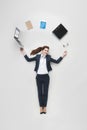 overhead view of businesswoman with various office supplies using laptop