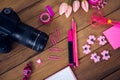 Overhead view of camera with office supplies and artificial tulip flowers Royalty Free Stock Photo