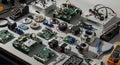 Assorted electronic components and tools including circuit boards gears motors multimeter pliers and screwdriver on gray surface Royalty Free Stock Photo