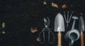 Rustic gardening tools arranged on dark fertile soil Royalty Free Stock Photo