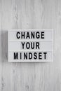 Overhead view, `Change your mindset` words on a lightbox on a white wooden background. Top view, from above, flat lay Royalty Free Stock Photo