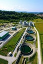 Overhead view of circular water treatment pools in a large, green wastewater facility. Royalty Free Stock Photo