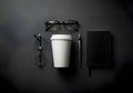 Overhead View of Coffee Cup, Glasses, and Notebook on Dark Textured Surface Royalty Free Stock Photo