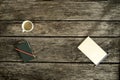 Overhead view of coffee, notebook and blank piece of paper