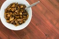 Overhead view of cooked mushrooms in a white bowl Royalty Free Stock Photo