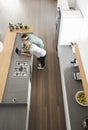 Overhead View Of Couple Looking At Laptop In Modern Kitchen Royalty Free Stock Photo