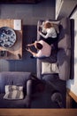 Overhead View Of Couple Relaxing On Lounge Sofa At Home And Playing Computer Game Together Royalty Free Stock Photo