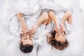 overhead view of couple with tissues lying in bed while Royalty Free Stock Photo