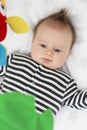 Overhead view of cute baby lying in crib or cot bed, looking at crib mobile toys Royalty Free Stock Photo