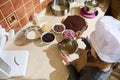 Overhead view of child girl confectioner using whisk, mixing ingredients in a metal bowl, standing by kitchen countertop Royalty Free Stock Photo