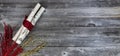 Top view of decorated white birch logs wrapped in cloth with red and golden flaming decorations on age wooden planks for a Merry Royalty Free Stock Photo