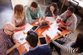 Overhead View Of Designers Having Meeting Around Table Royalty Free Stock Photo