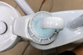 Overhead view of disposable glass filled with CHX mouth rinse next to spiotoon bowl in dental clinic