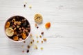 Overhead view, dried fruits and nuts in a pink bowl over white wooden surface. Top view, from above, flat lay. Copy space Royalty Free Stock Photo