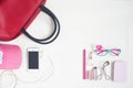 Overhead view of essential beauty items, Top view of smartphone, red hand bag, fashion eyeglasses and cosmetic