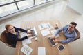 Overhead view of executives using laptop at desk Royalty Free Stock Photo