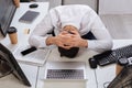 young businessman sitting near computers, smartphone Royalty Free Stock Photo