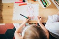 Overhead view female children sitting table drawing