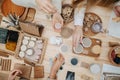 Overhead view of female customer hands picking various cosmetic products