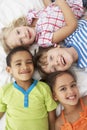 Overhead View Of Four Children Playing On Bed Together Royalty Free Stock Photo